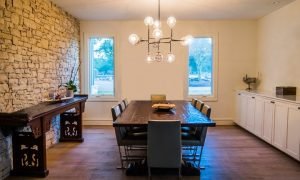 Modern dining room with timber floors and stone feature wall showing underfloor heating application