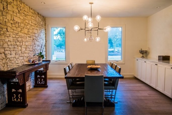 Modern dining room with timber floors and stone feature wall showing underfloor heating application